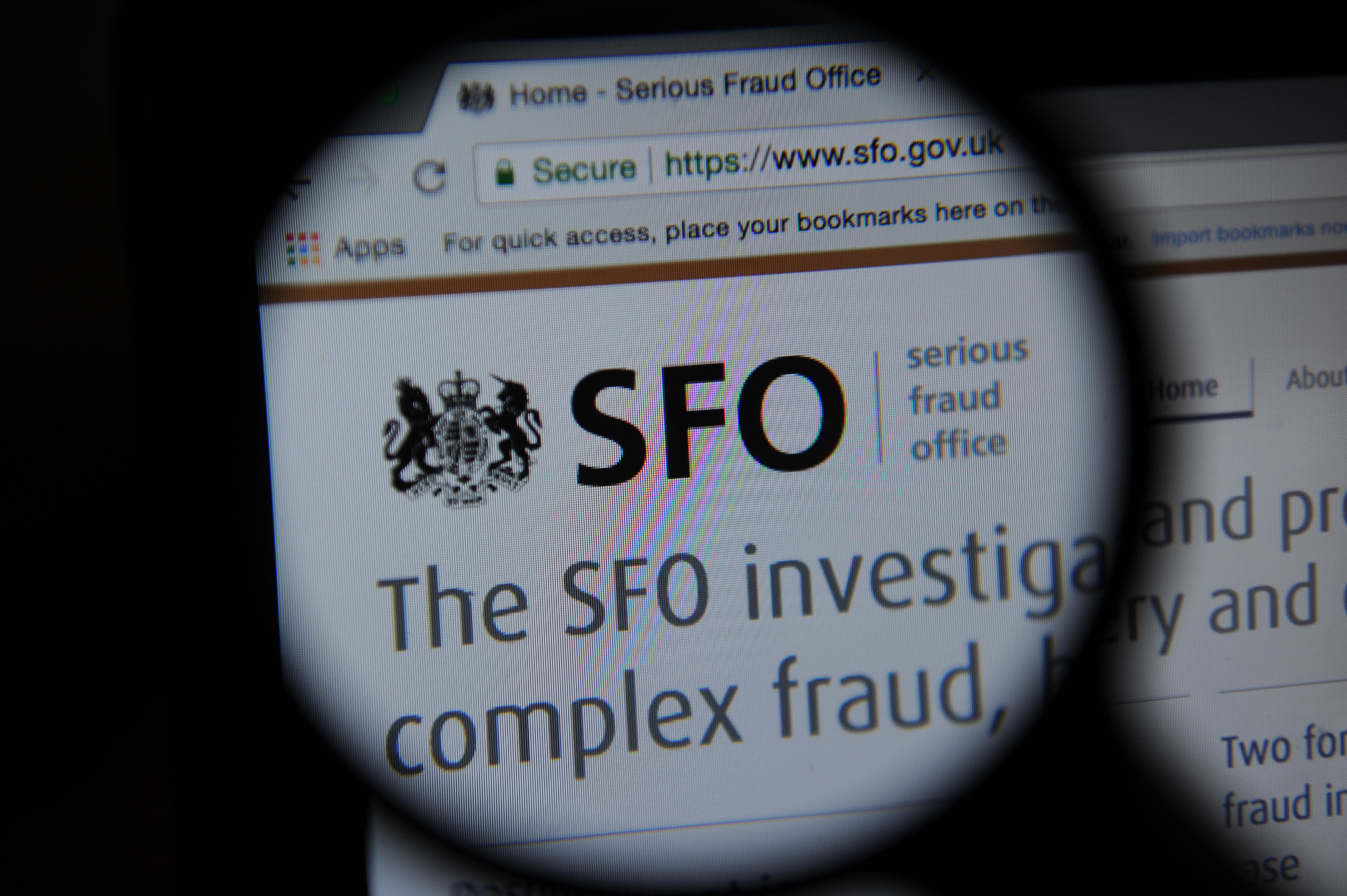 PD9807 The Serious Fraud Office website seen through a magnifying glass